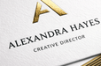 38pt white cotton letterpress business card featuring custom gold foil stamping and gold gilded edges for Alexandra Hayes