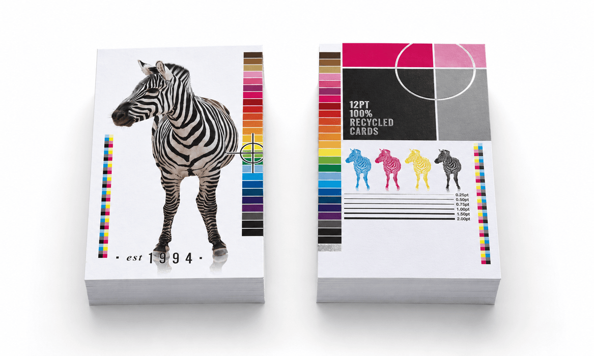 Stacks of custom-printed 100% recycled 12pt uncoated postcards for Clubcard Printing displaying a photorealistic zebra, four colorful zebra icons, and print calibration bars against a clean white background.