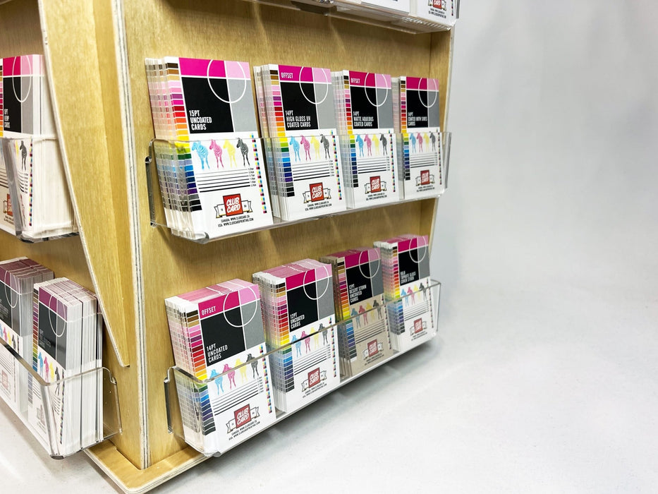 Angled view of 16-pocket birch plywood countertop card spinner filled with sticker packs - Clubcard Printing USA