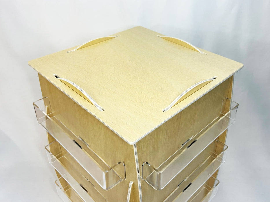High-angle top view of empty birch plywood countertop rotating card display rack with acrylic pockets - Clubcard Printing USA