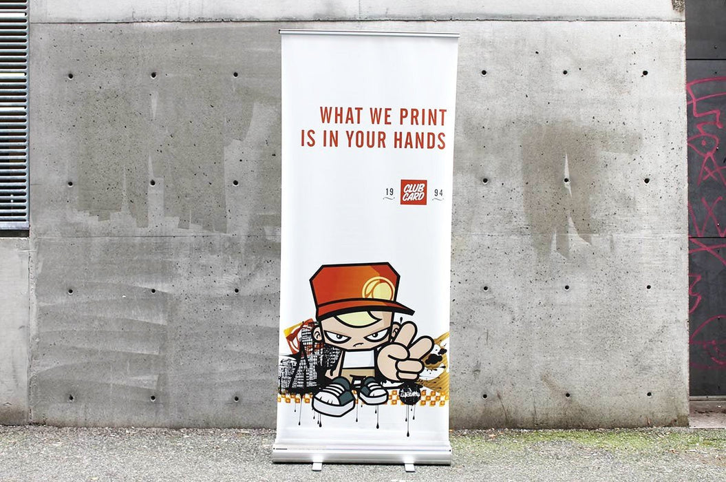 Clubcard Printing 33 wide by 80 tall retractable banner stand displayed against a concrete wall