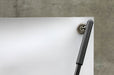 Close-up shot of top corner grommet attached to the upper hook of a 24x60 outdoor X banner stand