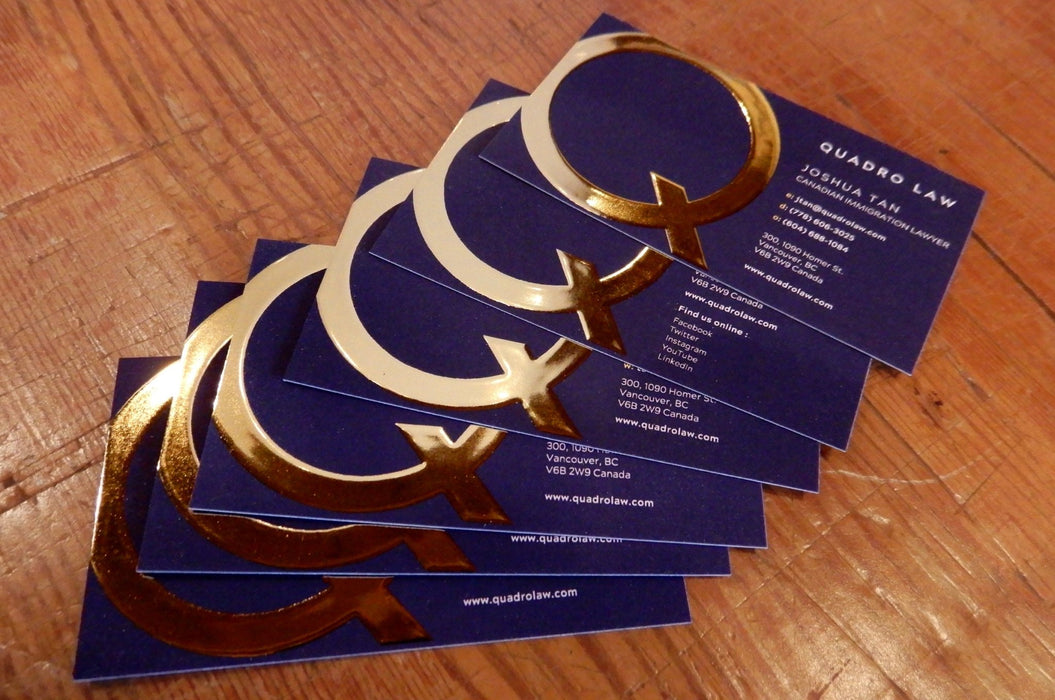 Raised gold foil business cards printed on 19pt suede stock with letter Q in raised gold metallic