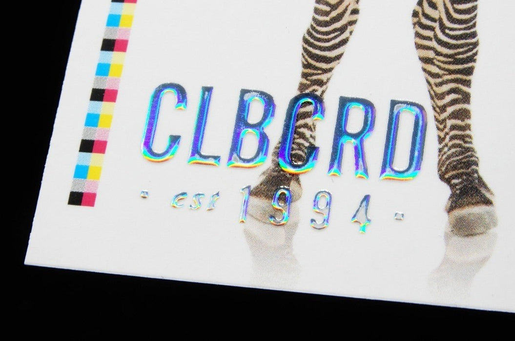 Close-up of Clubcard sample card on 19pt suede stock featuring CLUBCARD logo and small text in raised iridescent metallic foil