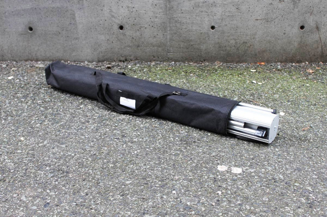 Black padded nylon travel carrying case with handles for a portable retractable banner stand. Clubcard Printing USA