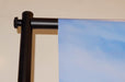 Close-up view of top corner connector clamp and horizontal crossbar attachment on a telescopic backdrop banner stand